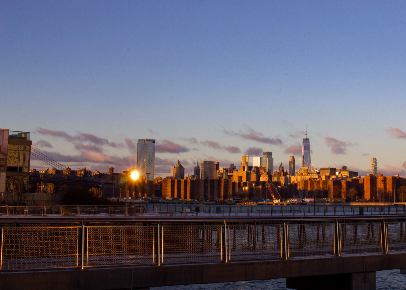 Photo of of the manhattan skyline nyc sunrise view from the Brooklyn Bridge Park - Pier 5 - photo credit: setarra